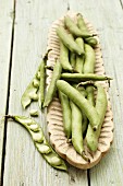 Broad beans in a wooden bowl