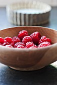 raspberries in a bowl with tart baking tins