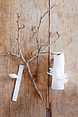 Twig and white vase on wooden surface