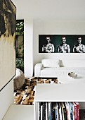 Living room with white leather sofa and modern artworks on walls