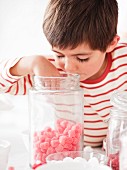 Boy Getting Candy from a Jar