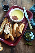 Liver pâté, toasted slices of white bread and pickled gherkins