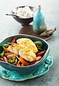 Wild salmon fillet with a wasabi & ginger crust on wild rice and Asian-style vegetables