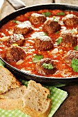 Falafels in tomato and paprika sauce with almonds and coriander
