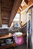 Rustic attic bathroom with small window