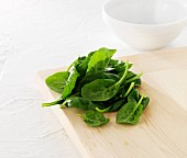 Spinach leaves on a chopping board