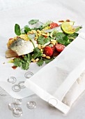 Trout in baking parchment with peanuts and coriander