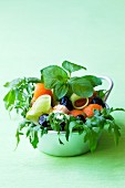 Salad with rocket, melon balls, cucumber, olives and mozzarella