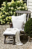 White cushions on deckchair in front of country house