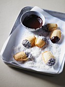 Madeleines dipped in chocolate and grated coconut
