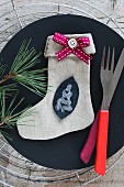 Christmas stocking (craft project) on plate with cutlery
