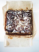 Cheesecake brownies on grease-proof paper