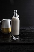 Nut milk in a jug and a bottle