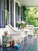 Summer porch with wicker furniture and flowers