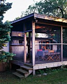 Screened in porch with airstream trailer during summer