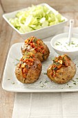 Baked potatoes with minced meat and vegetable filling and a yoghurt dip
