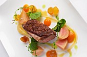 Duck breast with spring vegetables and pea shoots