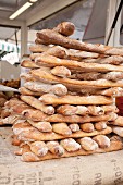 Freshly baked baguettes, stacked, in a bakery