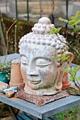 Head of Buddha decorating garden table