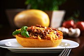 Spaghetti squash filled with tomato sauce and mushrooms, topped with cheese and baked