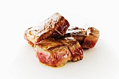 Seared Lamb Cubes on a White Background