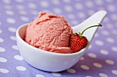 Home-made strawberry ice cream with a strawberry in a bowl