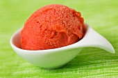 A scoop of home-made strawberry sorbet in a bowl