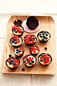 Chocolate cups filled with custard and berries