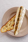 Brie filled with dried fruit on a slice of toasted bread