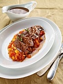 Pot-roasted shoulder of lamb with carrots and peppers