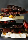 Assorted chunks of broken chocolate, stacked (close-up)