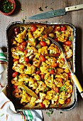 Baked cauliflower with turmeric, cherry tomatoes and shallots