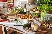 Rustic wooden table set with cold appetisers in Mediterranean ambiance
