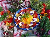 Tomatoes with mozzarella, basil and edible flowers