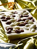 A slab of white chocolate with chocolate-covered raisins