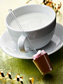 Hot milk with a stick of chocolate