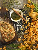 A still life featuring focaccia, chanterelles and thyme pesto