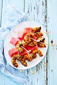Spicy prawn skewers with watermelon (view from above)