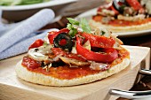 Mini pizza with peppers, mushrooms and olives