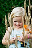 Smiling little girl carrying doll