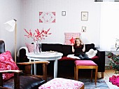 Girl sitting on sofa holding christmas decoration