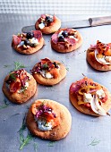 Assorted mini pizzas with salami, salmon and peppers