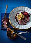 Duck fillet with a boozy plum sauce and chickpea purée