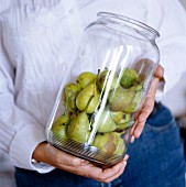 A woman holding a glass jar, Sweden.