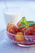 Fig and mirabelle plum compote with mint leaves