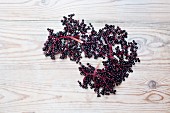 Elderberries on wooden background