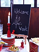 A welcome board for an after-work party on a table