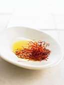Saffron strands in oil on a plate