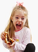 A small girl holding a hamburger
