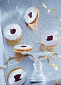 Vanilla Linzer biscuits (nutty shortcrust jam sandwich biscuits with holes on top) with Christmas decorations